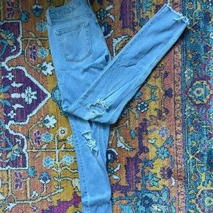 Just Black skinny jeans with distressing throughout in a size 27.